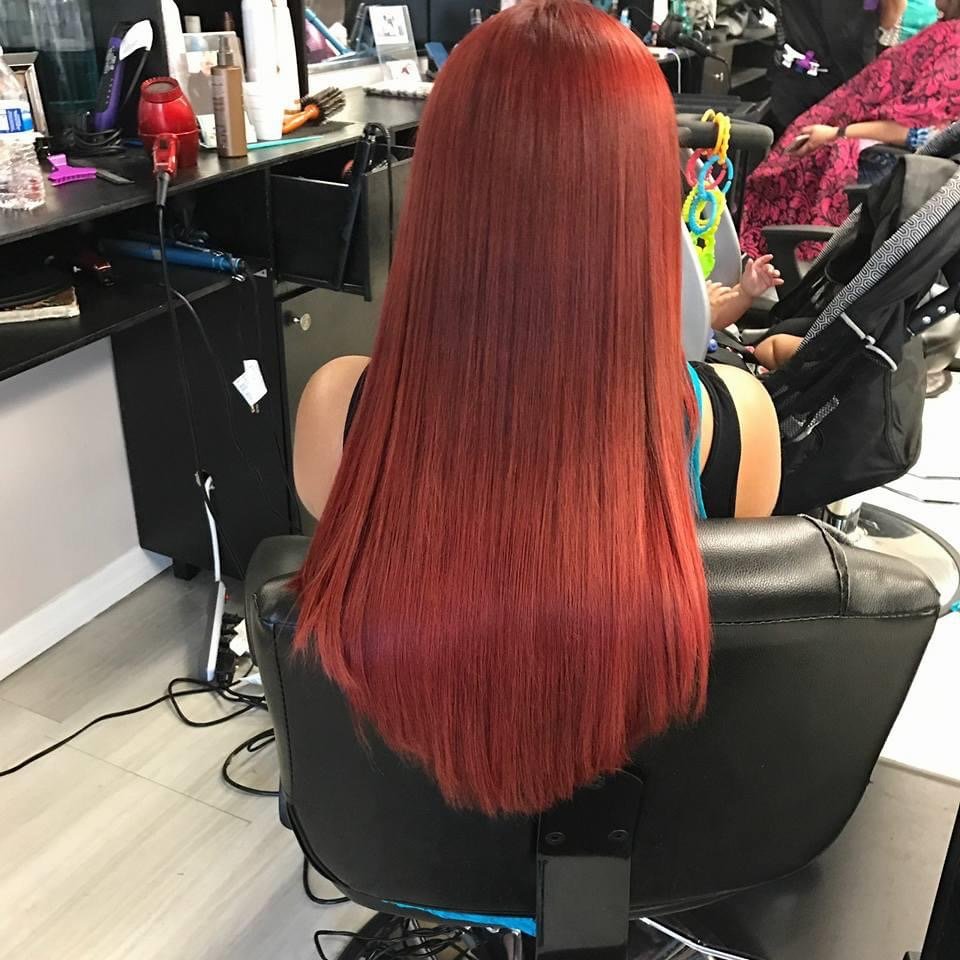 A stylist working on curly hair